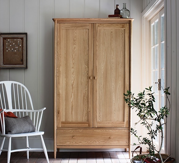 Ercol Teramo 2 door oak wardrobe in modern bedroom interior